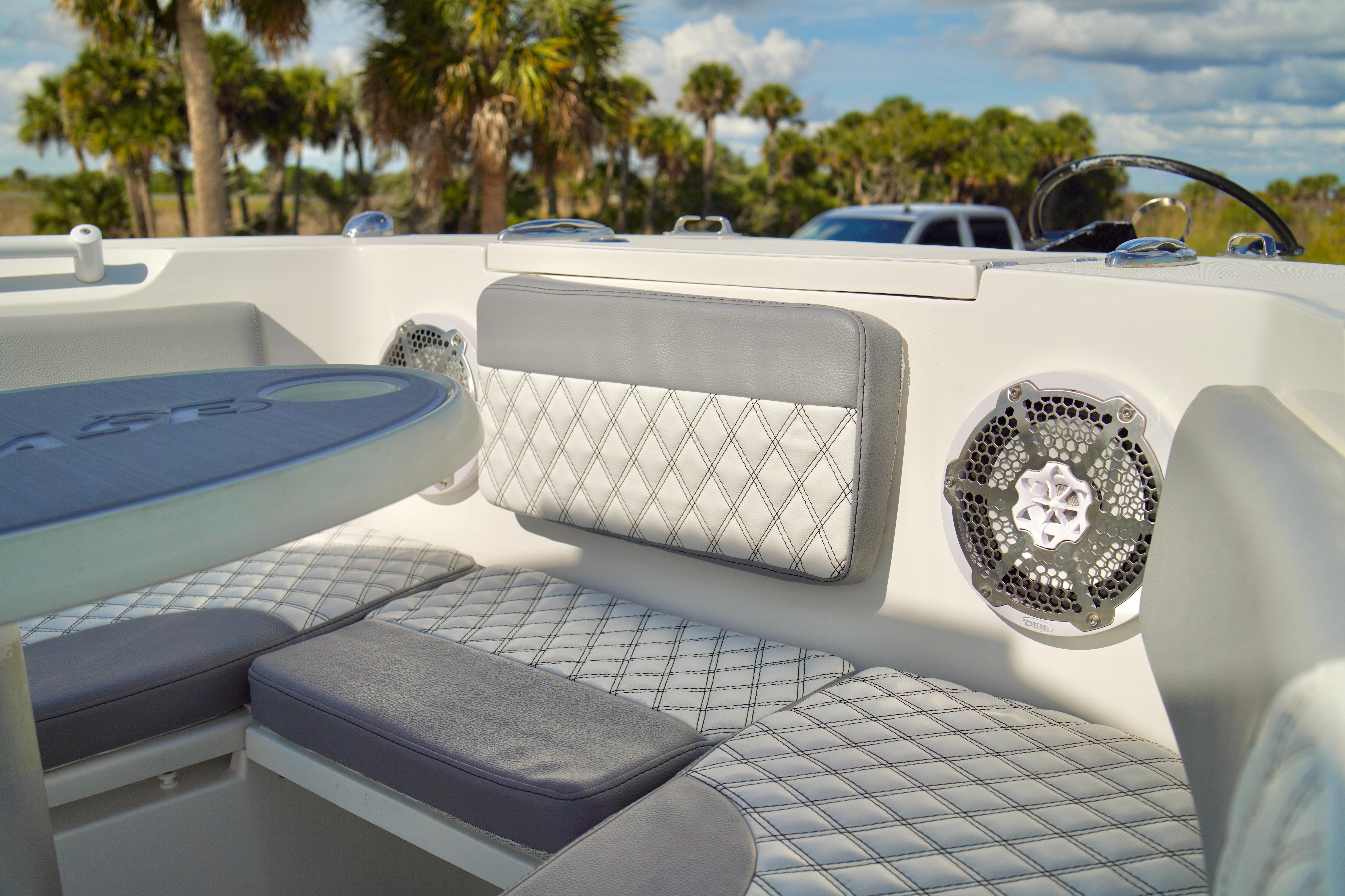Luxurious seating on 2017 Release 240 RX boat with diamond-stitched upholstery and speaker system.