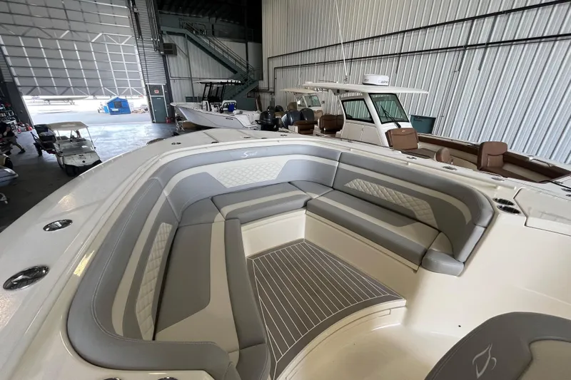 Zippy Yacht Photos Pics 2026 Scout 330 LXF boat interior with gray seating in a storage facility.