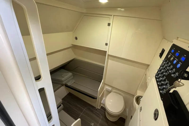 Zippy Yacht Photos Pics 2026 Scout 330 LXF cabin interior with seating, toilet, and control panel.