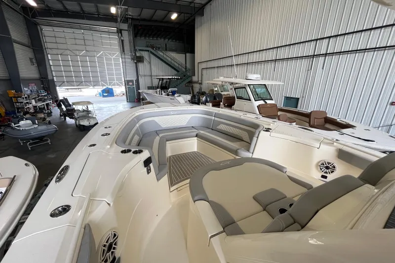 Zippy Yacht Photos Pics 2026 Scout 330 LXF boat in a spacious indoor storage facility.