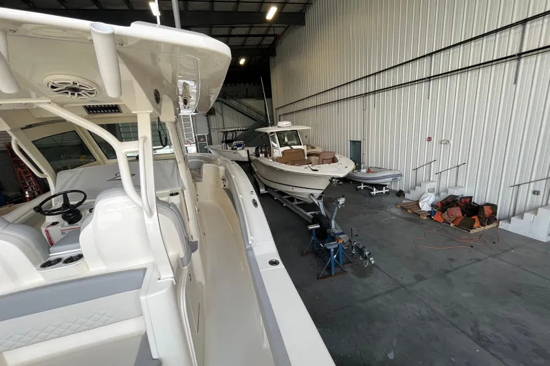 Zippy Yacht Photos Pics 2026 Scout 330 LXF boat in a spacious indoor storage facility.