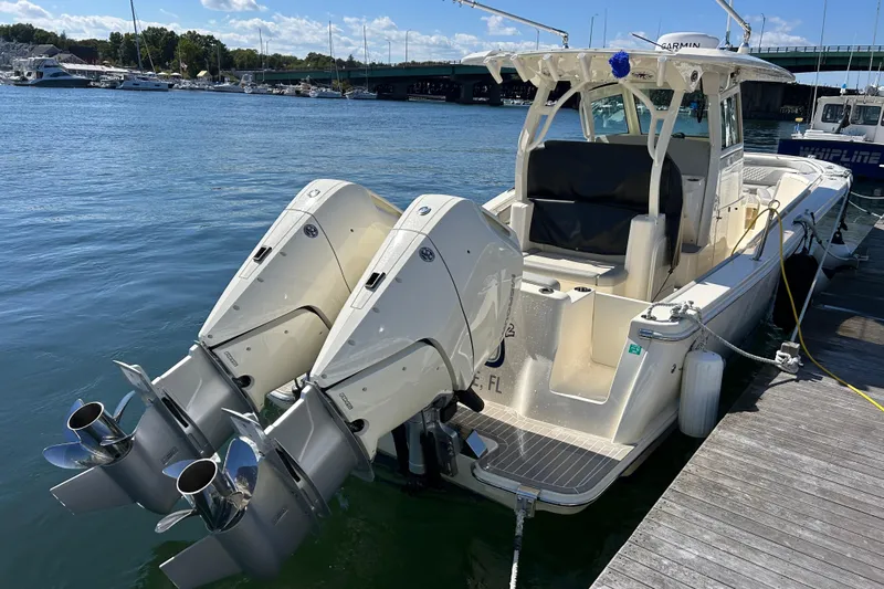 Zippy Yacht Photos Pics 2026 Scout 330 LXF boat docked with dual outboard engines.
