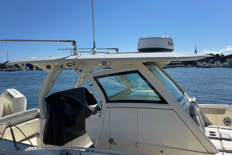 Zippy Yacht Photos Pics 2026 Scout 330 LXF boat docked by the water on a sunny day.