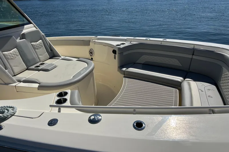 Zippy Yacht Photos Pics Luxurious seating area on 2026 Scout 330 LXF boat, featuring elegant design and ocean backdrop.