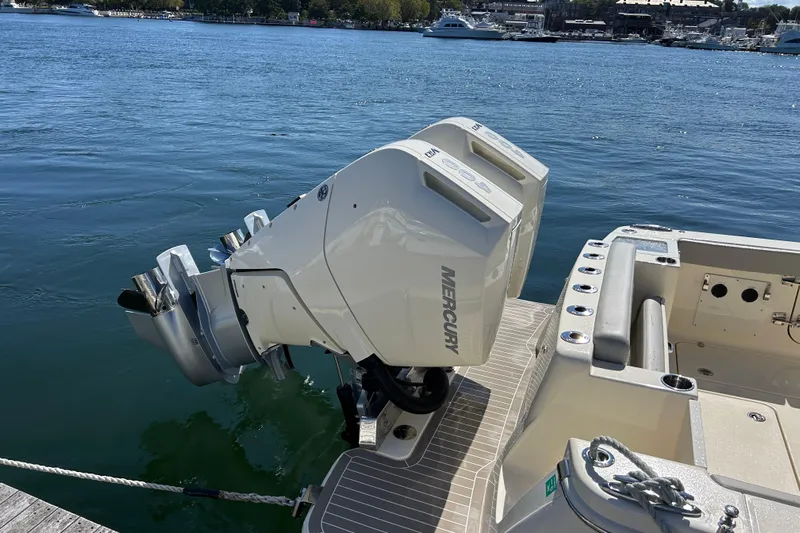 Zippy Yacht Photos Pics 2026 Scout 330 LXF boat with Mercury outboard engines docked by the water.