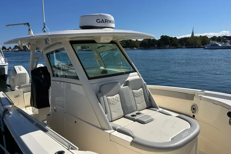 Zippy Yacht Photos Pics 2026 Scout 330 LXF boat with Garmin equipment, docked on a sunny day by the water.