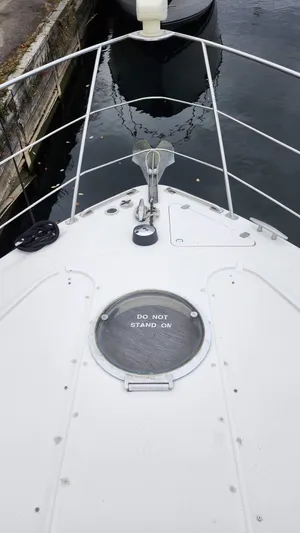  Yacht Photos Pics 2005 Carver 420 Mariner boat deck with anchor and safety warning.