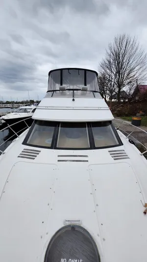  Yacht Photos Pics 2005 Carver 420 Mariner yacht with sleek design, docked under cloudy skies.