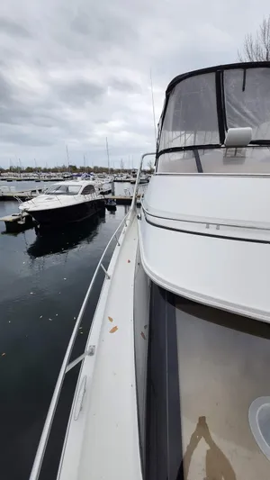  Yacht Photos Pics 2005 Carver 420 Mariner yacht docked at marina on a cloudy day.