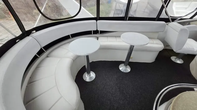  Yacht Photos Pics Luxurious seating area on 2005 Carver 420 Mariner yacht with modern tables and plush upholstery.