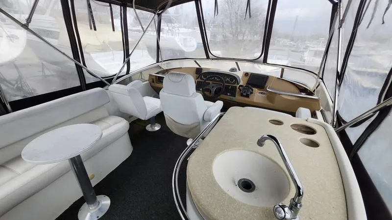  Yacht Photos Pics 2005 Carver 420 Mariner interior with helm, seating, and sink.