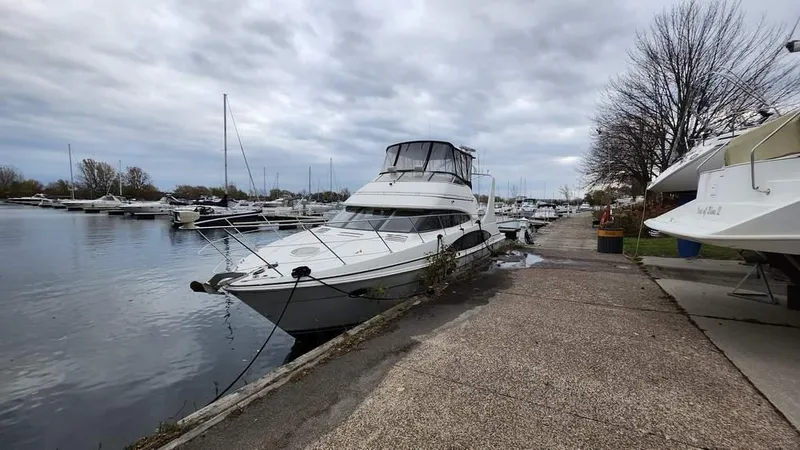  Yacht Photos Pics 2005 Carver 420 Mariner yacht docked at a marina under cloudy skies.