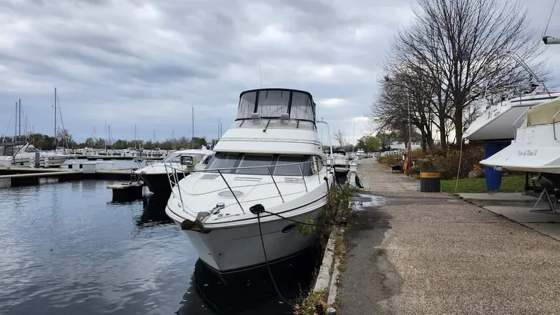  Yacht Photos Pics 2005 Carver 420 Mariner yacht docked at a marina under cloudy skies.
