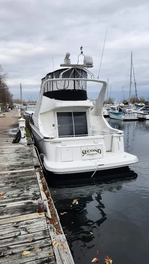  Yacht Photos Pics 2005 Carver 420 Mariner docked at a marina on a cloudy day.