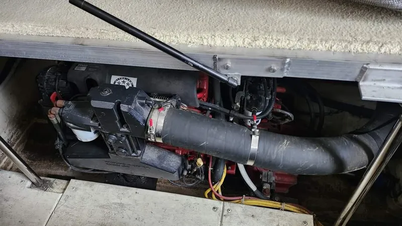  Yacht Photos Pics Engine compartment of a 2005 Carver 420 Mariner boat, showing mechanical components and hoses.