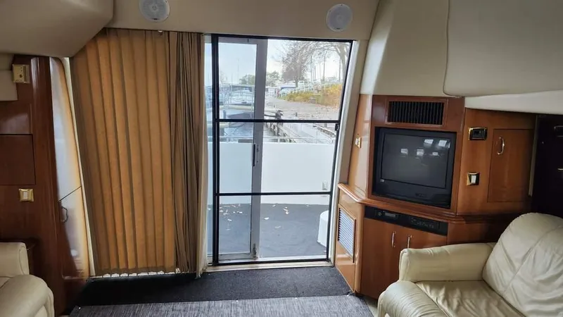  Yacht Photos Pics Interior of 2005 Carver 420 Mariner yacht with TV, seating, and sliding door.