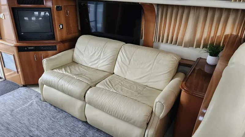  Yacht Photos Pics Luxurious interior of 2005 Carver 420 Mariner with leather sofa and entertainment center.