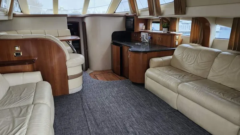  Yacht Photos Pics Luxurious interior of 2005 Carver 420 Mariner yacht with leather seating and wood accents.