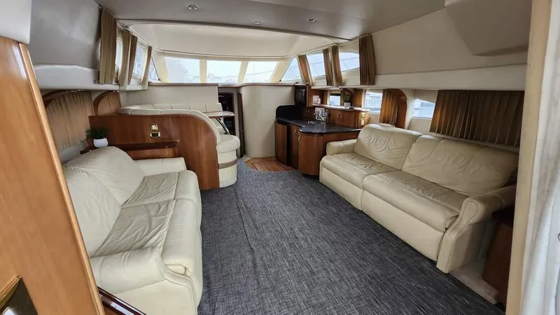  Yacht Photos Pics Luxurious interior of 2005 Carver 420 Mariner yacht with leather seating and wood accents.