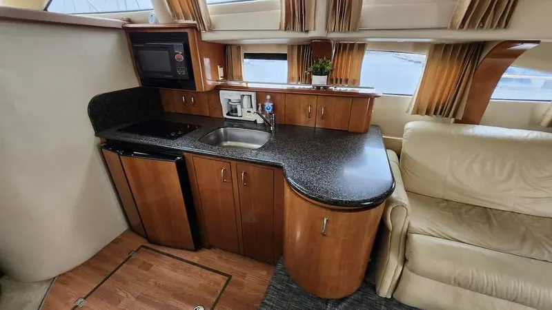  Yacht Photos Pics 2005 Carver 420 Mariner yacht interior with kitchenette and seating area.