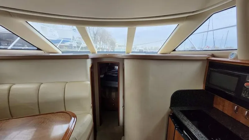  Yacht Photos Pics Interior of 2005 Carver 420 Mariner yacht with seating and kitchenette.