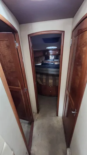  Yacht Photos Pics 2005 Carver 420 Mariner interior hallway with wood finish and bedroom view.