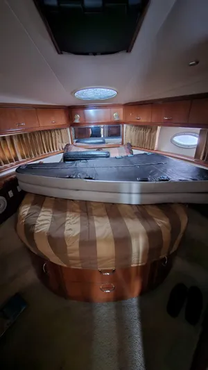  Yacht Photos Pics Interior of 2005 Carver 420 Mariner yacht with luxurious wood finish and circular bed.
