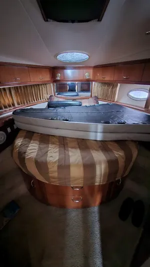  Yacht Photos Pics Interior of 2005 Carver 420 Mariner yacht with luxurious wood finish and circular bed.