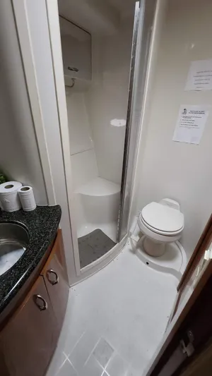  Yacht Photos Pics 2005 Carver 420 Mariner bathroom with shower, toilet, and sink.