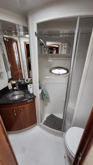  Yacht Photos Pics Bathroom interior of 2005 Carver 420 Mariner yacht with shower, sink, and toilet.