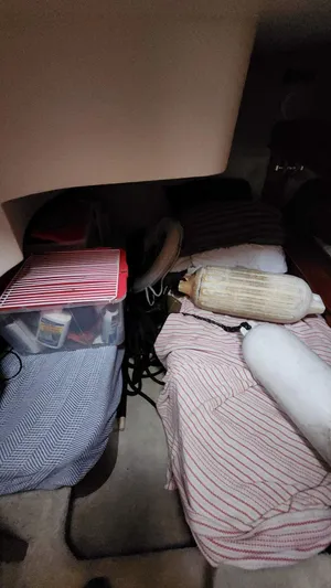  Yacht Photos Pics Interior cabin of 2005 Carver 420 Mariner with striped bedding and storage containers.