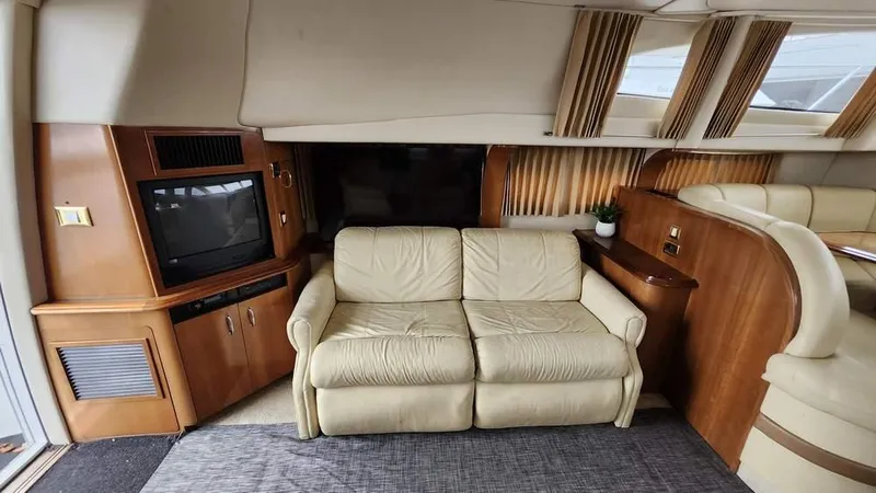  Yacht Photos Pics Interior of 2005 Carver 420 Mariner yacht with beige sofa and built-in TV.