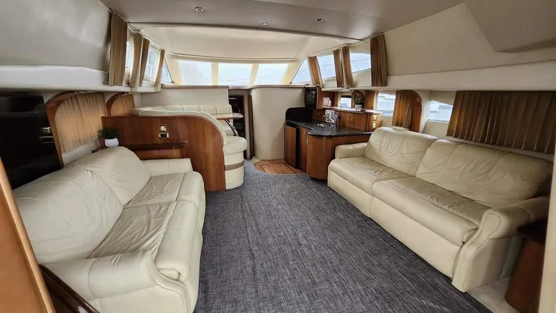  Yacht Photos Pics Luxurious interior of 2005 Carver 420 Mariner yacht with leather seating and wood accents.