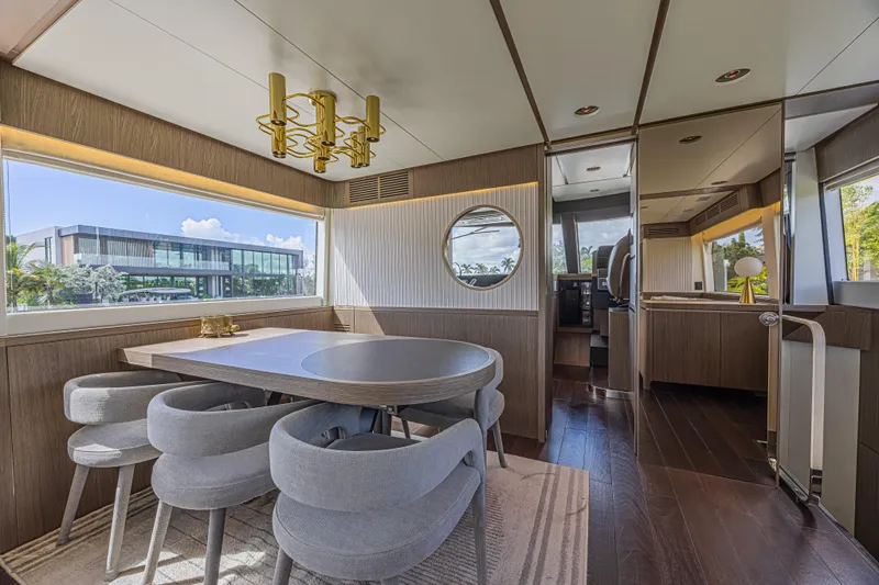  Yacht Photos Pics Luxurious interior of 2022 Azimut Magellano 66 yacht with elegant dining area and modern decor.
