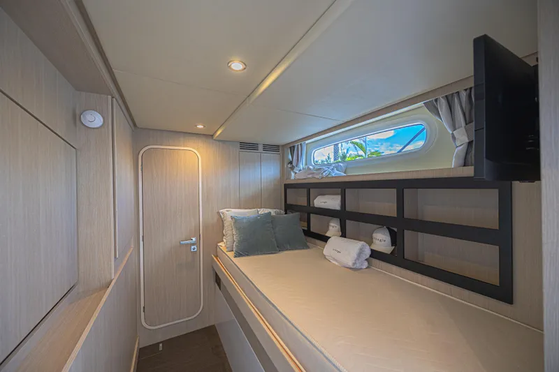 Yacht Photos Pics Luxurious cabin interior of 2022 Azimut Magellano 66 yacht, featuring modern design and comfortable bedding.