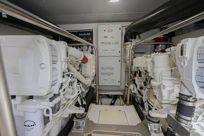  Yacht Photos Pics Engine room of 2022 Azimut Magellano 66 yacht, featuring dual MAN engines and control panels.