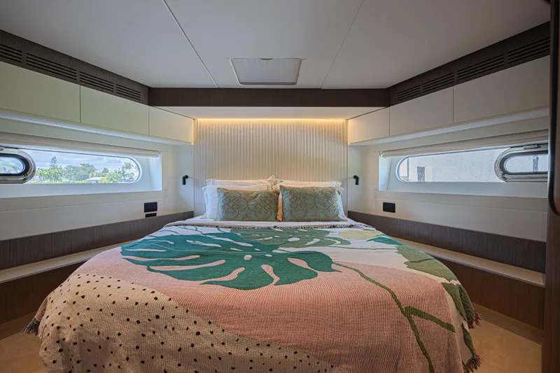  Yacht Photos Pics Luxurious bedroom interior of 2022 Azimut Magellano 66 yacht with stylish bedding and windows.