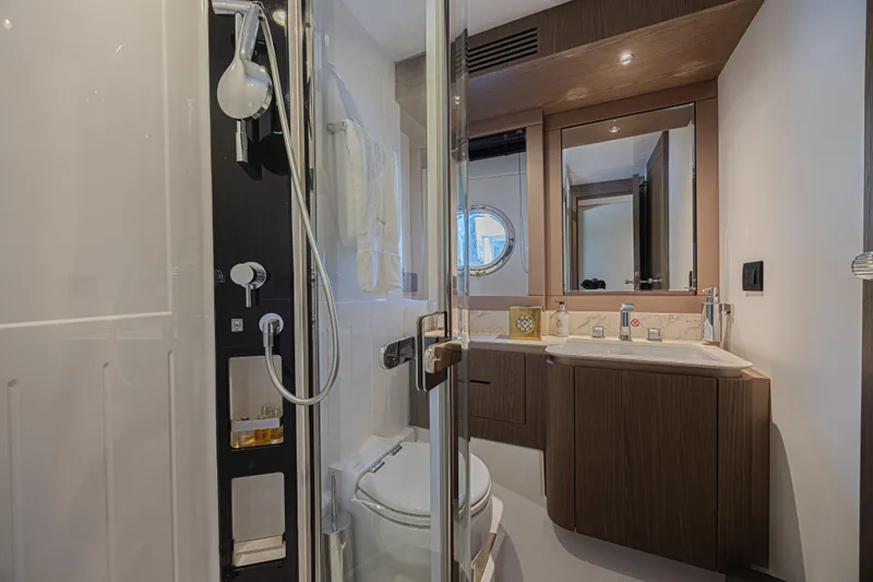  Yacht Photos Pics Luxurious bathroom in 2022 Azimut Magellano 66 yacht, featuring modern fixtures and elegant design.