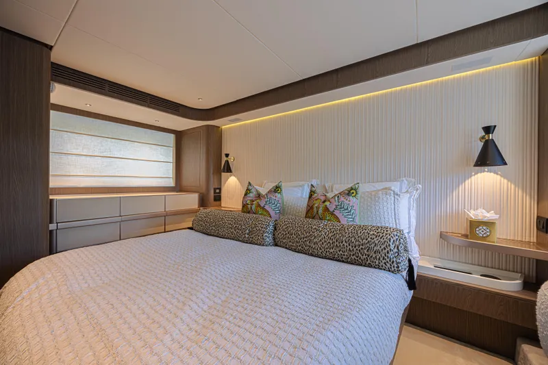  Yacht Photos Pics Luxurious bedroom interior of 2022 Azimut Magellano 66 yacht with elegant decor and ambient lighting.