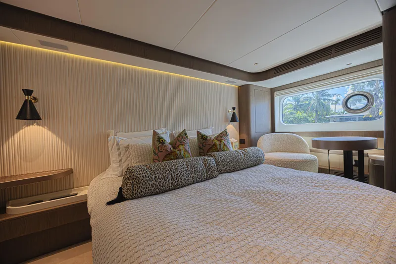  Yacht Photos Pics Luxurious bedroom interior of 2022 Azimut Magellano 66 yacht with elegant decor and large window.