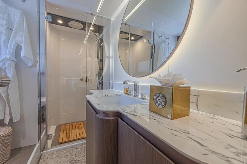  Yacht Photos Pics Luxurious bathroom in 2022 Azimut Magellano 66 yacht with marble countertop and modern shower.