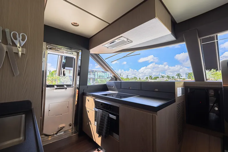  Yacht Photos Pics Modern kitchen interior of 2022 Azimut Magellano 66 yacht with scenic window view.