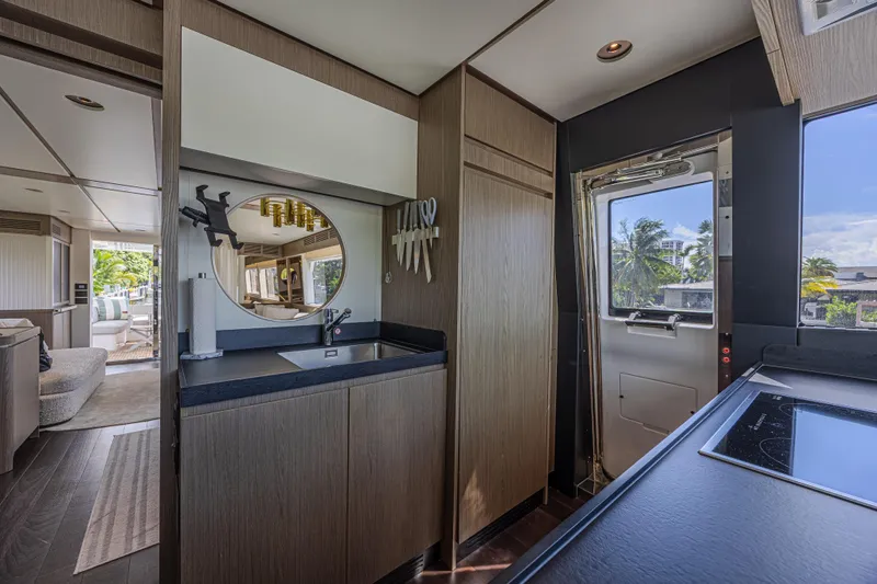  Yacht Photos Pics Luxurious interior of 2022 Azimut Magellano 66 yacht with modern kitchen and scenic view.