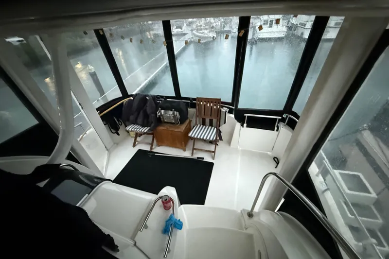  Yacht Photos Pics 2005 Meridian 368 Motoryacht interior with chairs and marina view.