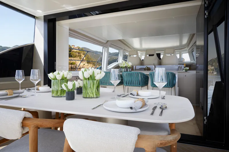 Edge 65 Yacht Photos Pics Luxurious dining area on 2023 Van der Valk Edge 65 yacht, featuring elegant table setting.