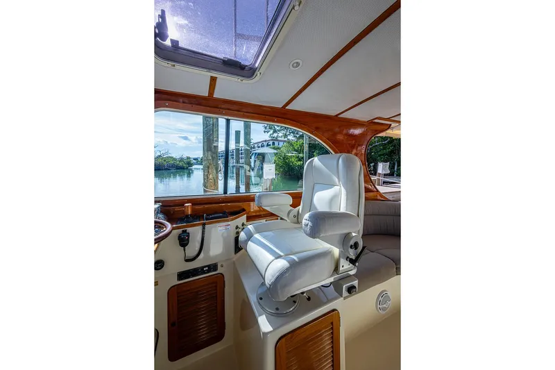 Miss Betty Yacht Photos Pics Interior of 2002 Hinckley Talaria 40 yacht with white captain's chair and scenic window view.