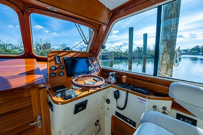 Miss Betty Yacht Photos Pics Helm of 2002 Hinckley Talaria 40 yacht with wooden dashboard and scenic water view.