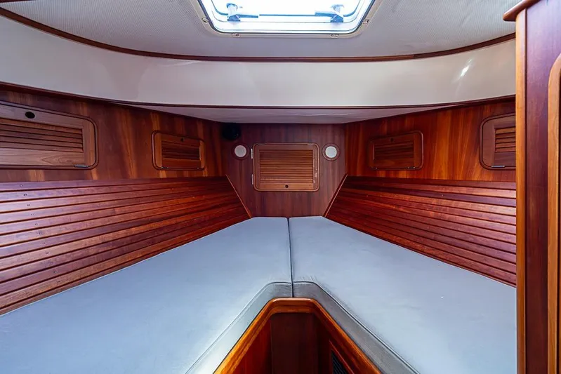 Miss Betty Yacht Photos Pics Interior cabin of 2002 Hinckley Talaria 40 yacht with wooden paneling and skylight.
