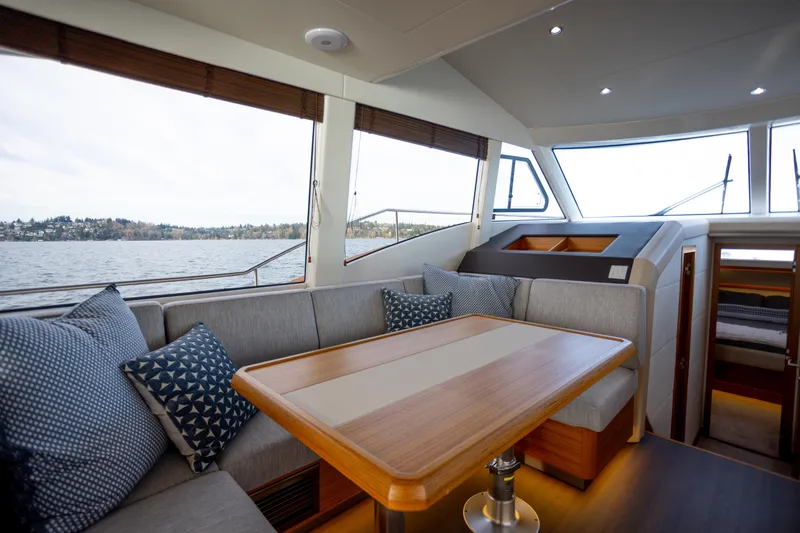 Tui Yacht Photos Pics Luxurious interior of 2023 Greenline 48 Fly yacht with elegant seating and scenic water view.