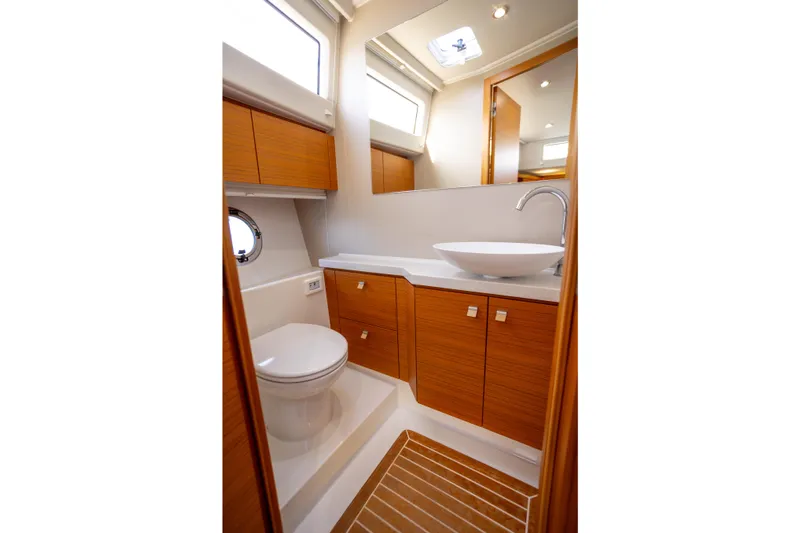 Tui Yacht Photos Pics Luxurious bathroom in 2023 Greenline 48 Fly yacht with modern fixtures and wood accents.